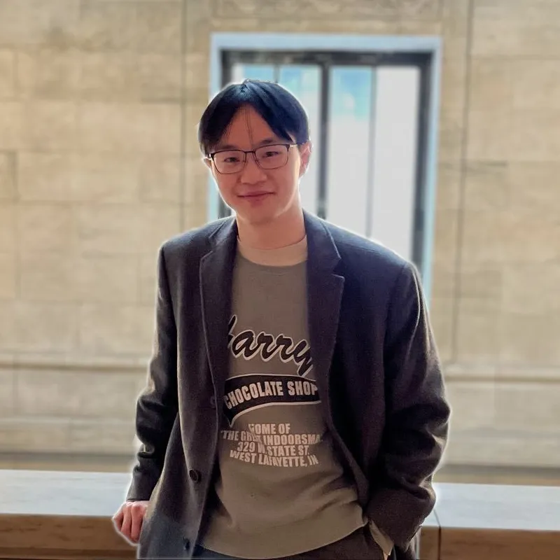 Alan smiling at the camera in the New York Public Library